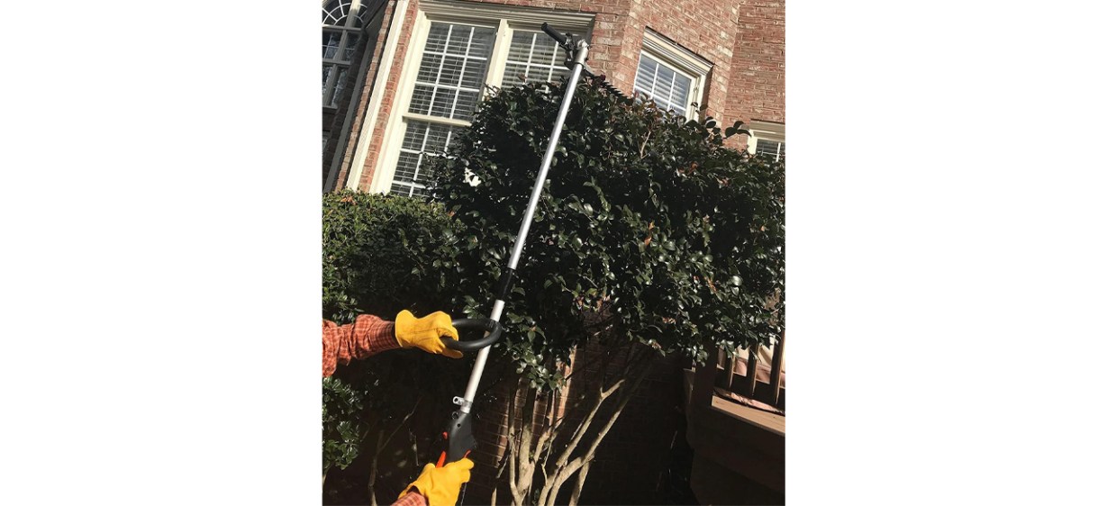 Person using Sunseeker Weed Whacker on hedge