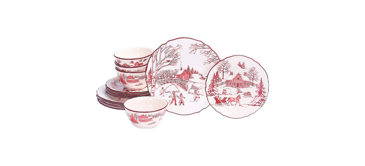 White plates and bowls with red edges and depicting a farmhouse winter scene