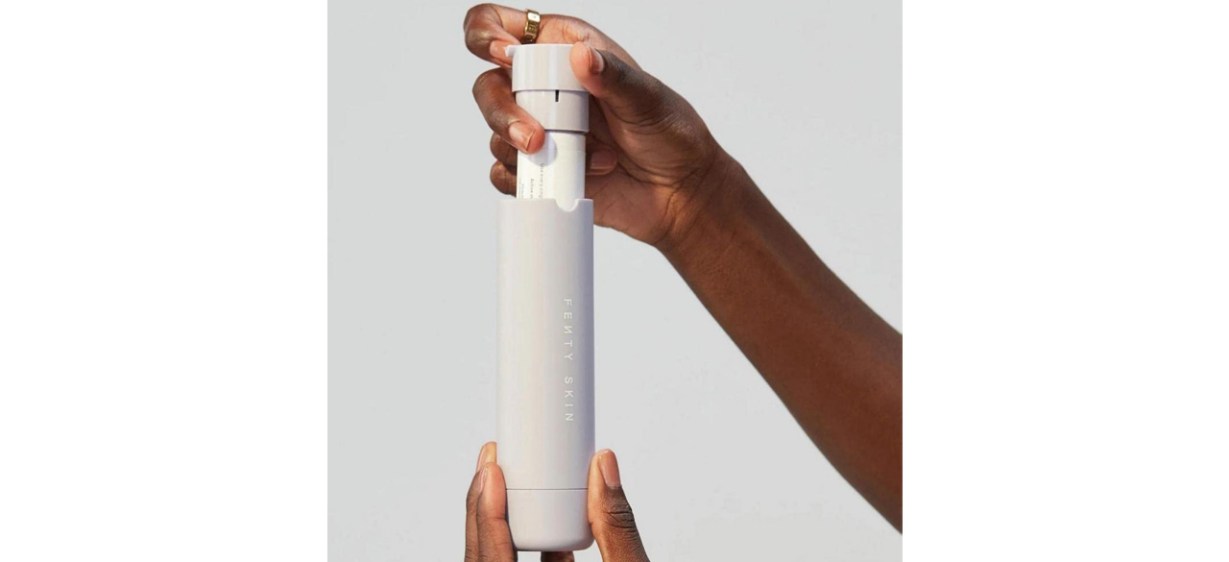 Person holding Fenty Skin Hydra Vizor Broad Spectrum Mineral SPF 30 Sunscreen Moisturizer