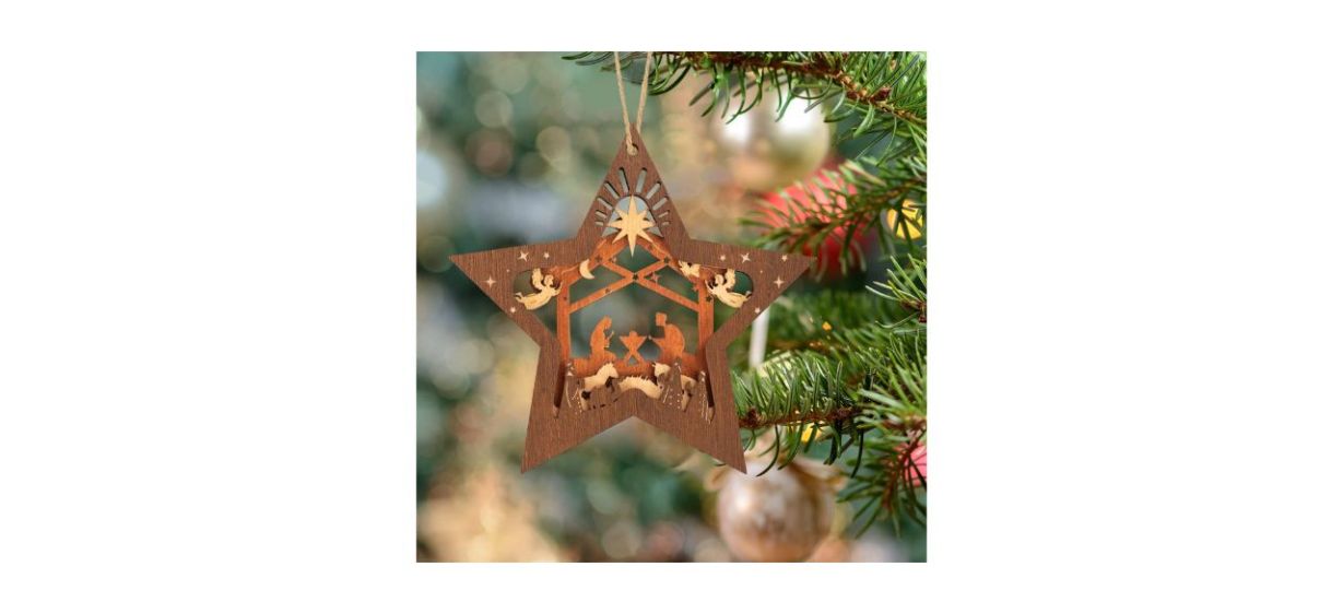 a wooden star-shaped nativity scene ornament hanging on a tree a wooden star-shaped nativity scene ornament hanging on a tree