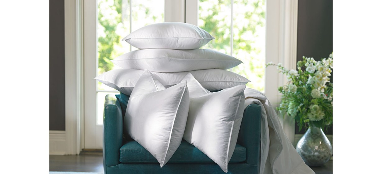 The Ritz-Carlton Pillows stacked on chair