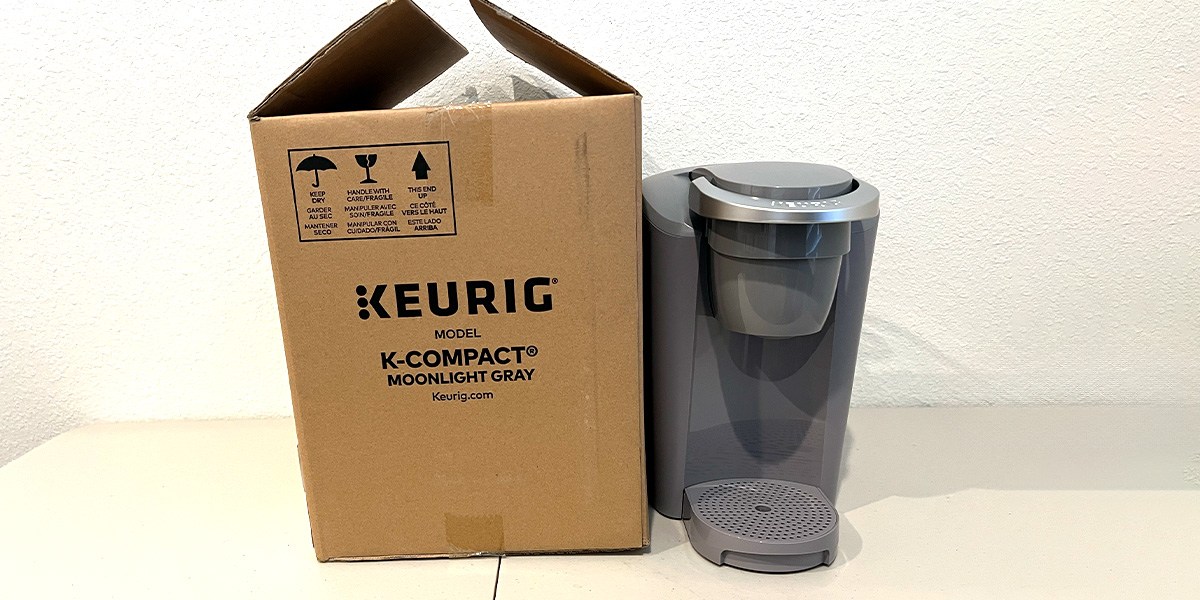 Keurig K-Compact on counter next to product packaging Keurig K-Compact on counter next to product packaging