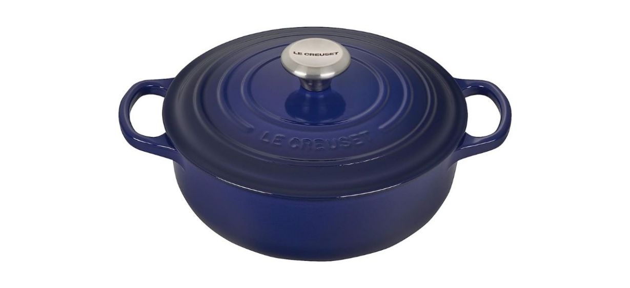 A somewhat flat blue enameled saucepan with a lid on top and a handle on each side