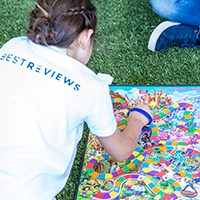 Child playing board game outdoors