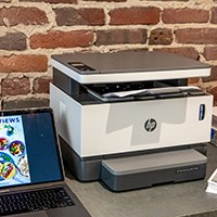 Printer next to laptop on table