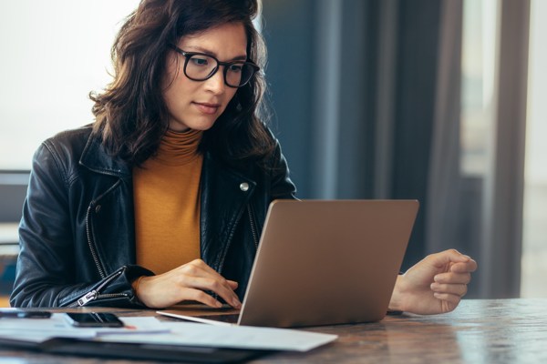 Woman working on a laptop at a table