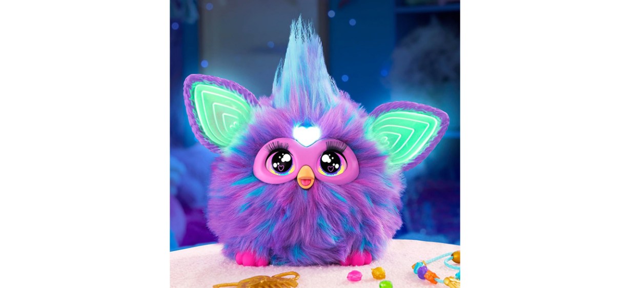 Purple, green, blue and pink Furby on white background