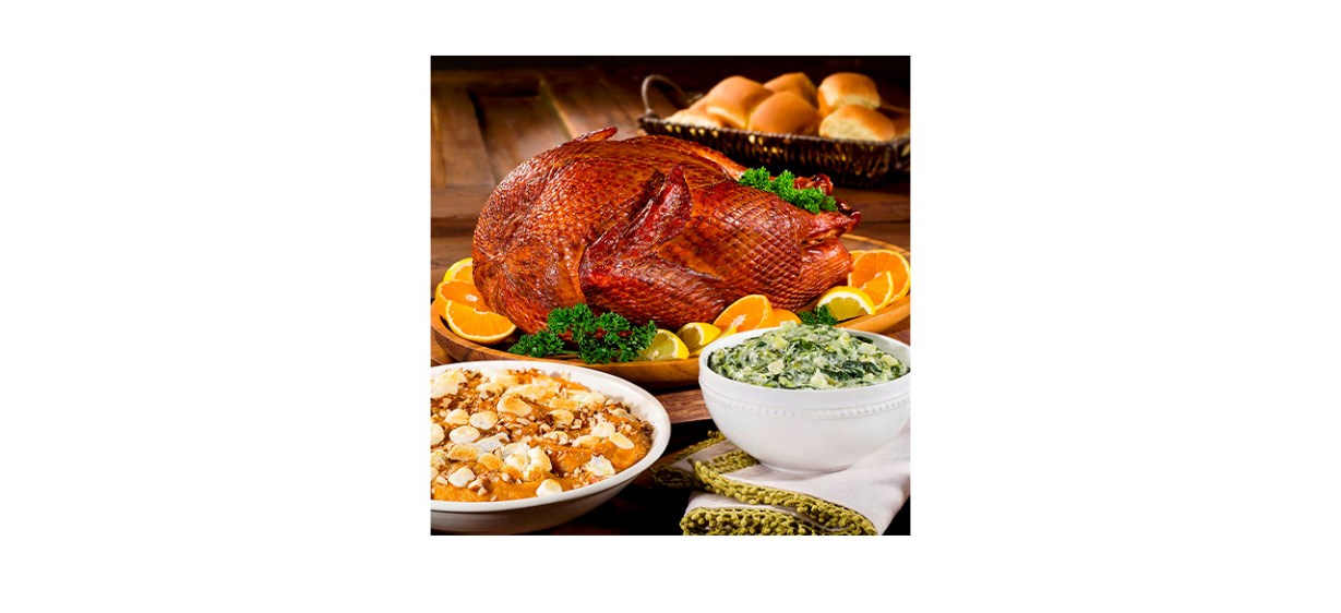 Hickory Smoked Whole Turkey (11-13 Pounds) on a table with side dishes