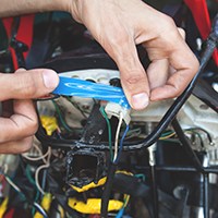 hands using electrical tape